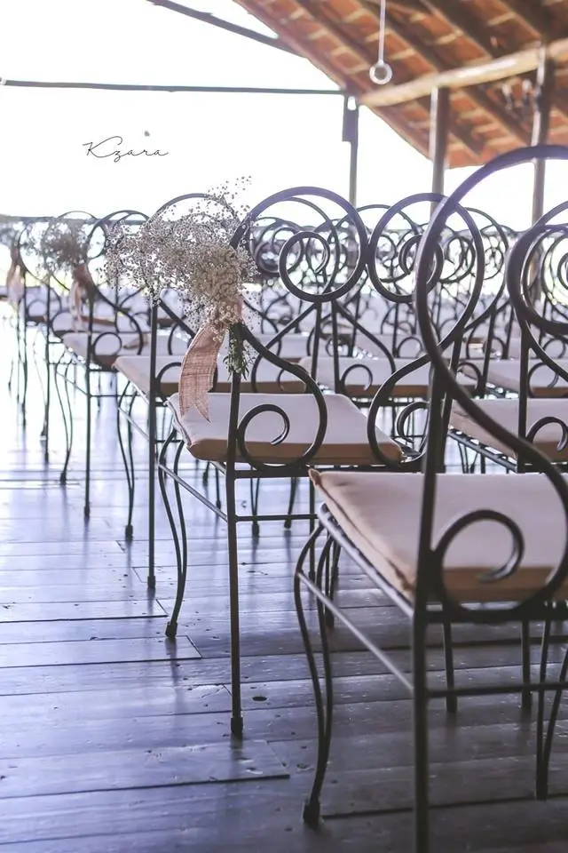 Chairs set out for a ceremony under the thatch