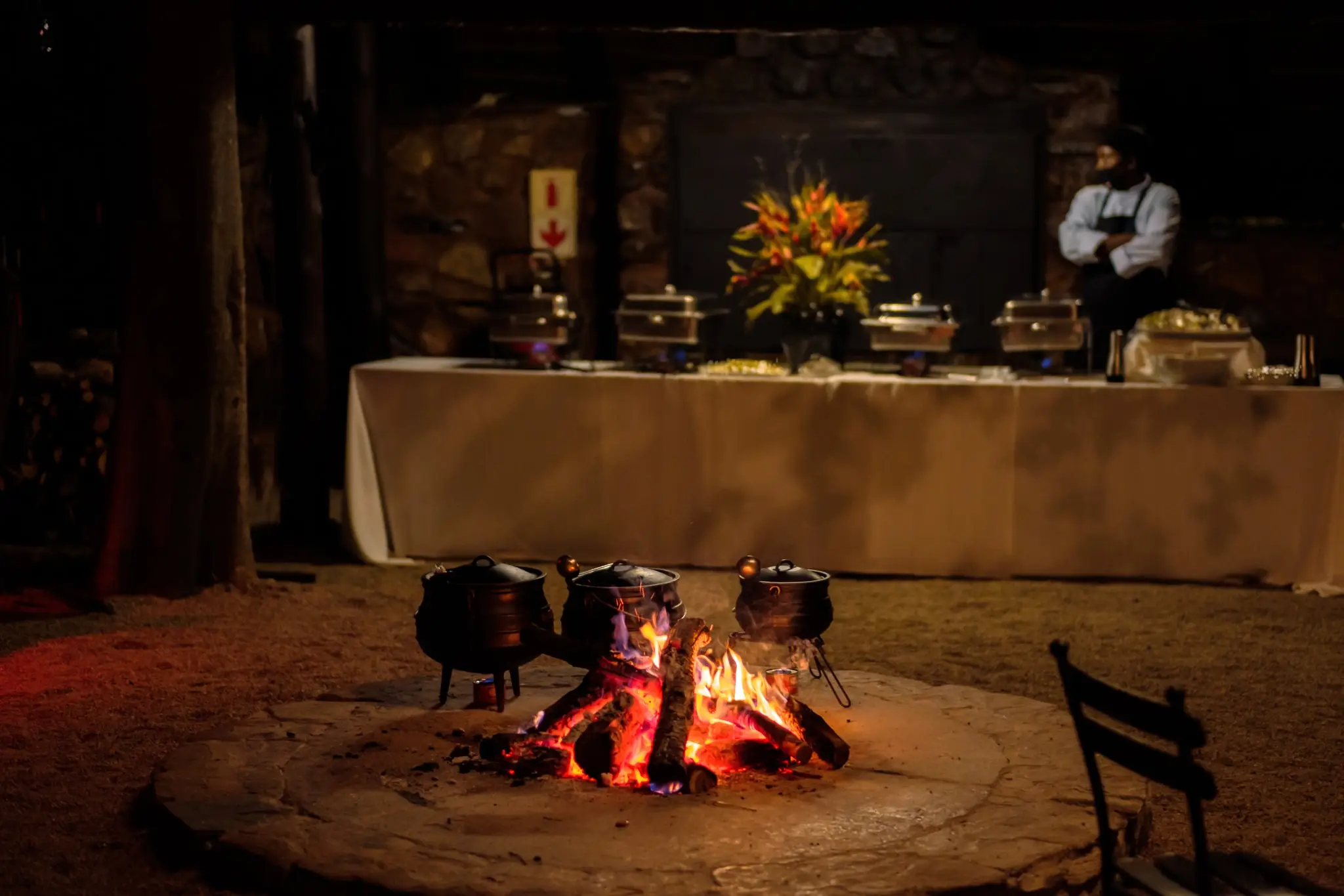 A buffet set beside the boma fire at night
